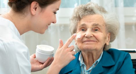 Photo of an older woman receiving a facial