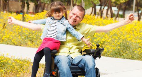 photo of Disabled Father showing freedom with his little daughter.