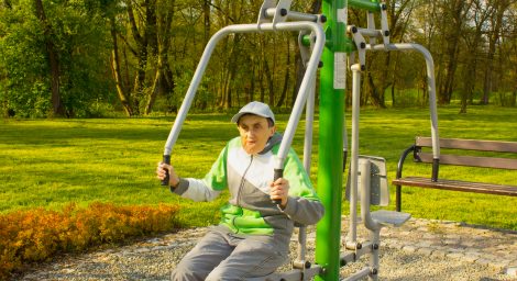 Photo of disabled man using outside gym