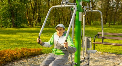 Photo of disabled man using outside gym