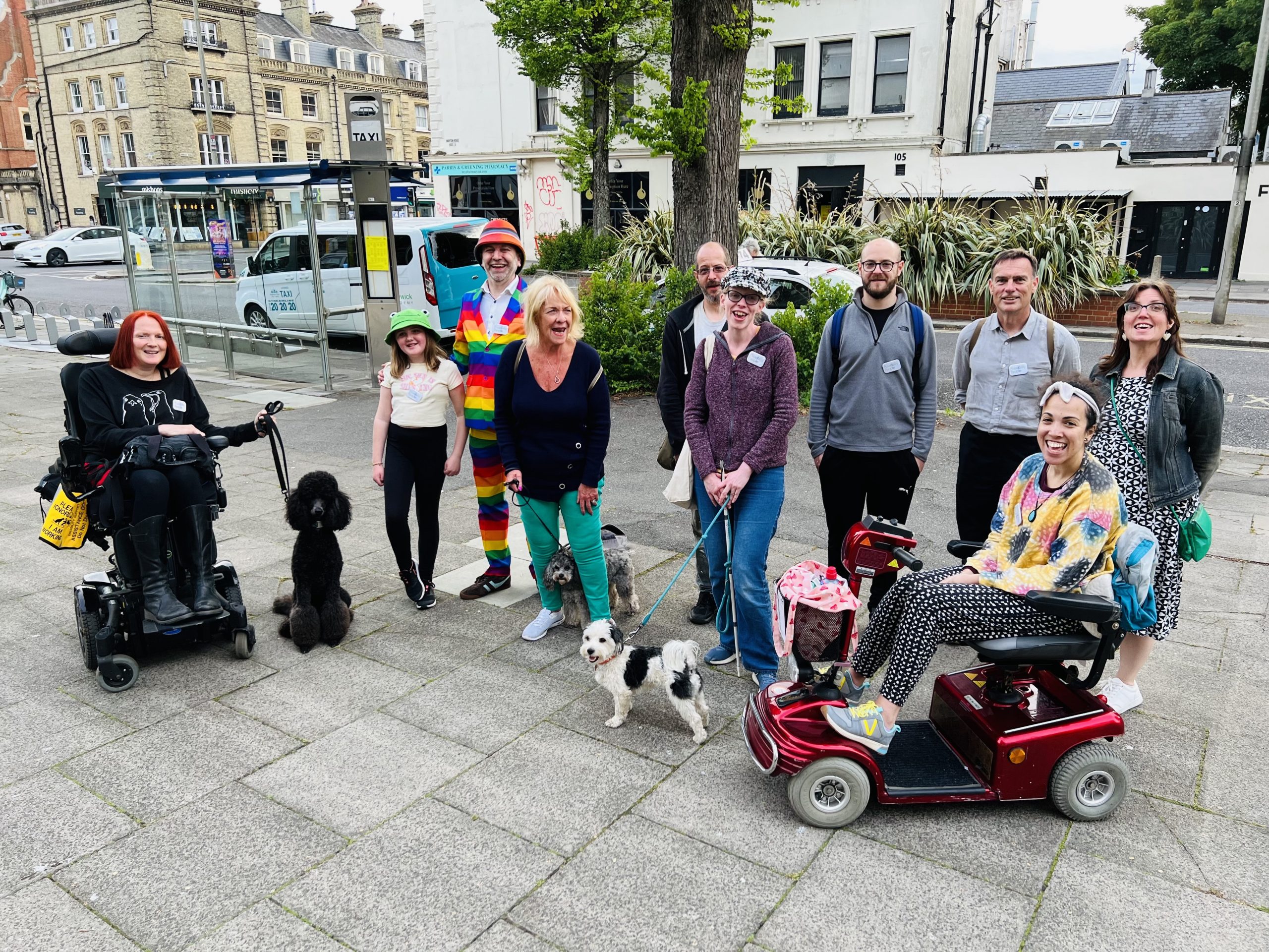 Group of people, including two wheelchair users, gathered together