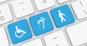 a zoomed in image of a white computer keyboard with some keys replaced to show disabled symbols in blue, including a key for a wheelchair user, a key for vision impaired people and a key for hearing impaired people
